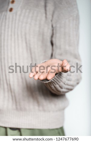 Man holding on his hand invisible object. Place your product here