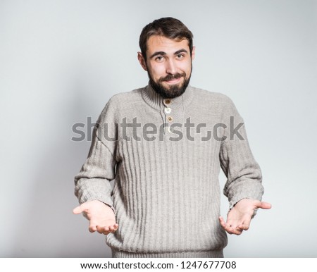 handsome bearded man holding something invisible, close-up on the background