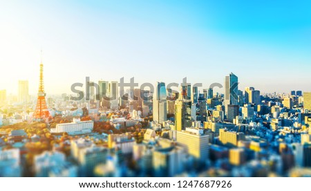 Asia business concept for real estate and corporate construction - panoramic city skyline aerial view with tokyo tower under blue sky & sun in Tokyo, Japan with tilt shift, miniature, blur effect