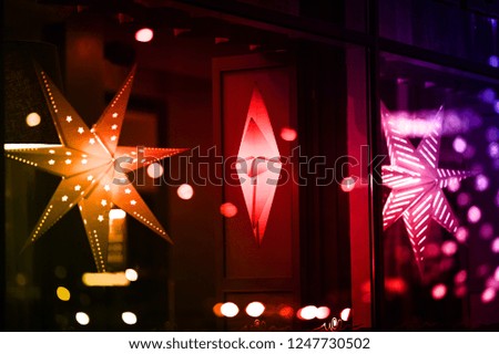Christmas stars on a dark background. Stars of different shapes and structures. Have different colors.