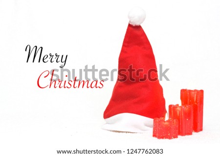 Christmas Santa claus hat and red candles on white isolated
