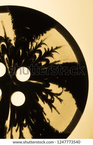Transparent button with pattern. macro view. black silhouette