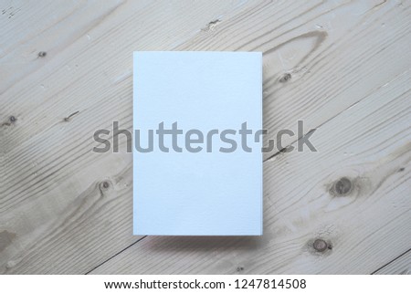 White empty paper blank isolated for your design at light wooden background flat lay mock up