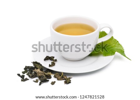 Mulberry tea in white cup with fresh green leaf and dried tea leaves isolated on white background