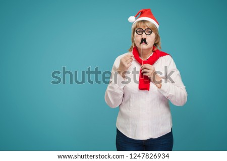 Middle-aged woman on background with the face of emotions, christmas, office.