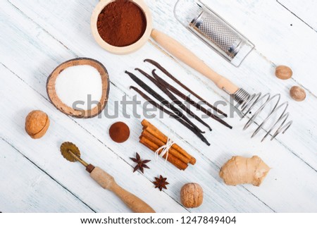 dessert ingredients and kitchen utensils on old white wooden table