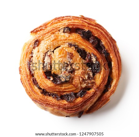 Freshly baked sweet bun with raisins isolated on white background, top view Royalty-Free Stock Photo #1247907505
