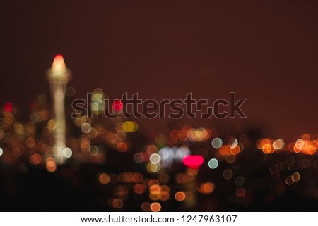 Various sized bokeh of the city of Seattle skyline at night