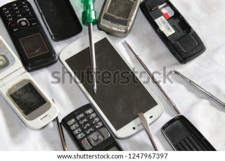 Old mobile phones all together being serviced or repaired. We can see here Mobile evolution.