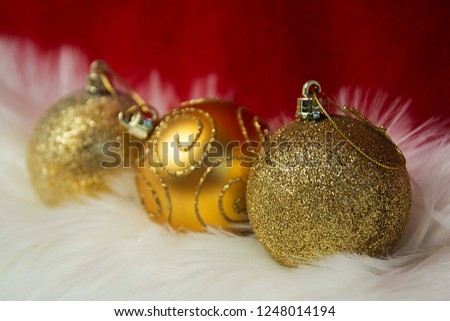 Border of white fur over festive red brocade. Golden baubles decorations.Lots of copy-space.