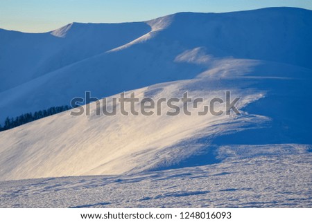 Amazing winter mountains landscape. Mountain hills covered by snow. Carpathian mountains, Ukraine