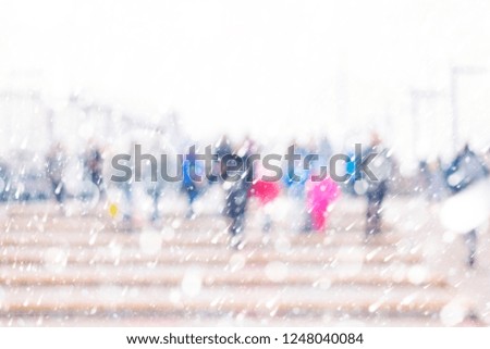 abstract blurred background of people walking in a blizzard