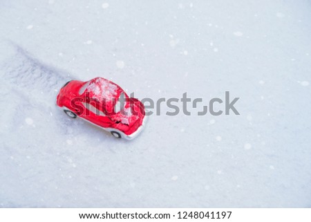Christmas red toy auto on snow background. new year and christmas holiday concept. festive winter season. top view. copy space