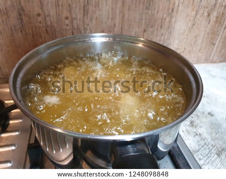 Frying chicken with oil, Oil is boiling. Royalty-Free Stock Photo #1248098848