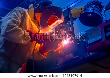 Welder. The man does the work. A man at work. Welding work. Welder costume. Working. Welding mask. Welding electrodes.