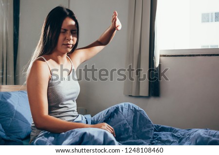 Girl upset waking up with the light bothering her lying on a bed in the morning Royalty-Free Stock Photo #1248108460