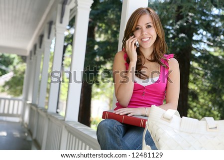 A pretty teenage girl on the cell phone at home