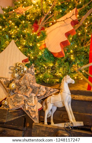 Retro antique wooden horse  and nostalgic Christmas decoration with antique toys over wooden background. Retro style picture. Holiday greeting card. Vintage style photo.