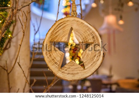Christmas decoration with flowers, wooden antique toys and lights. House interior. Retro style picture. Vintage style photo.