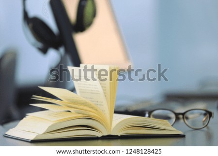 Close-up of  book opened on computer desk in sound lab selective focus and shallow depth of field