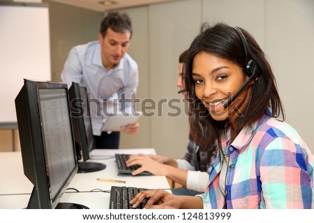 Portrait of cheerful young woman with headset on