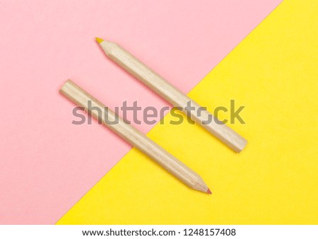 Colored pencils on yellow and pink background. Flat Lay Photography