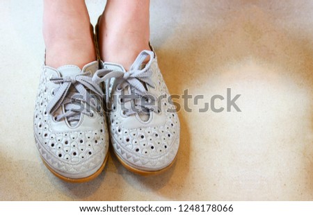 Female feet with shoes relaxing on wooden floor with copy space for advertising.