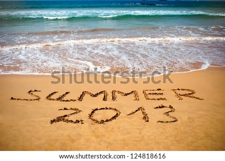 Inscription on wet sand Summer 2013. Concept photo of summer vacation. Royalty-Free Stock Photo #124818616
