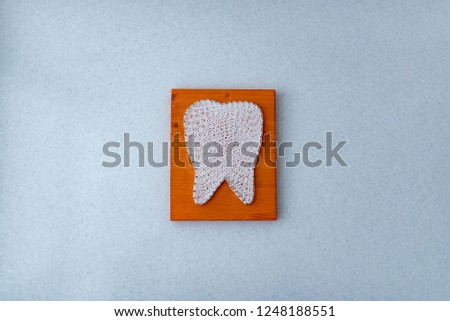 string art tooth diy on wooden desk top flat view on wall