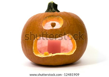 Jack-o-Lantern cyclops isolated on white with a candle burning inside giving a glow.