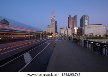 
Evening Columbus Ohio skyline along the Scioto River at dusk with car trails