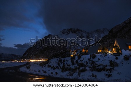 View of  Mount Cook Village covered with white snow after a snowy day at night.