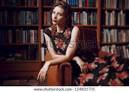 Beautiful fashionable student sitting in the university library