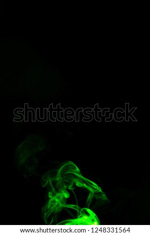 Green coloured smoke abstract lighting on a black background