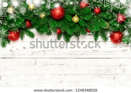 Christmas decoration with fir branches, snowflake  on white board wooden background  with copy space.