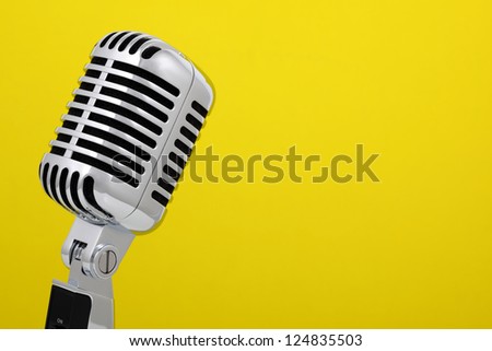 Retro microphone isolated on yellow background