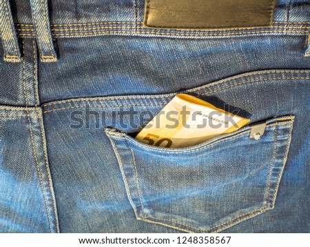 Fiftey euro banknotes in jeans pocket. Money in the jeans pocket, close up