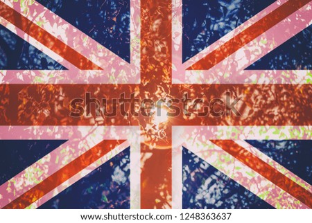 British flag on a trees background and sun rays.