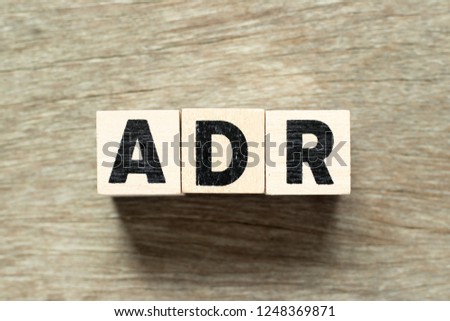 Letter block in word ADR (Abbreviation of adverse drug reaction) on wood background Royalty-Free Stock Photo #1248369871