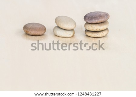 Stable cobblestones stacked on a wooden board