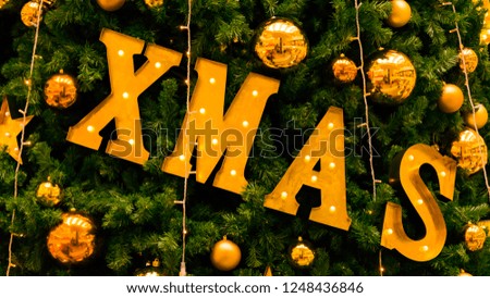 christmas xmas sign on christmas tree and christmas lights background
