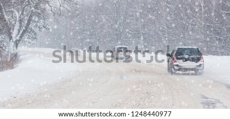 Winter, snow, Blizzard, poor visibility on the road. Car during a Blizzard on the road with the headlights. Royalty-Free Stock Photo #1248440977