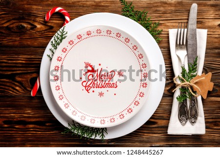Christmas table setting conceptual design with fork, knife and festive attributes. New Year banquet serving appointment options with silverware. Background, close up, top view, flat lay, copy space.