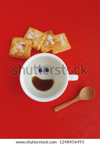 Top view cup of some coffee or tea as happy fun face smile with biscuits, teaspoon on red background Hot beverage breakfast refreshment creative idea image design poster advertisement, Flat lay banner