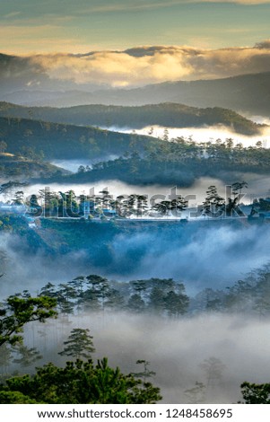 Beautiful images of the radiant dawn with reflecting rays through the fanciful clouds on over the pine forests, which created an impressive breathtaking scene of highlands in the morning in Dalat, VN