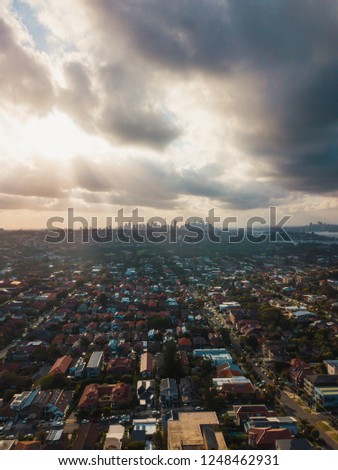 Aerial view of Sydney CBD at the distance under the sunlight with cloudy sky.