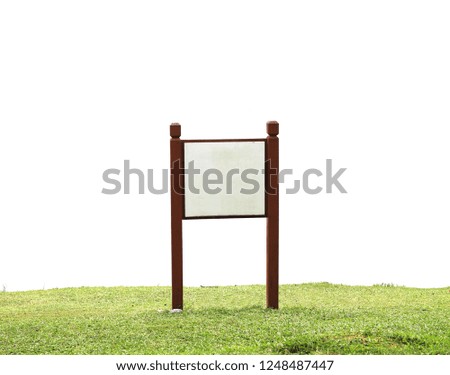 blank wood sign on green grass hill