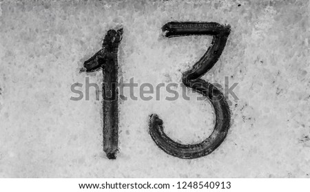 Close up outdoor view of number thirteen 13 written in white on a black and white square plate. Numerical sign fixed at a house exterior wall to indicate the address in street. Vintage design image