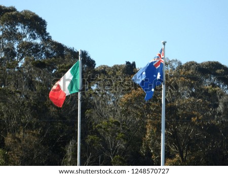 Italian and austrlian flags flying together