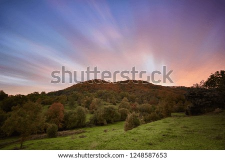Nice long exposure picture, cloudscape over the mountain in sunset and autumn colors